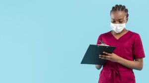 female-doctor-wearing-mask-writes-clipboard